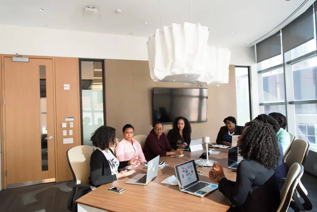 Women sitting together in the boardroom.